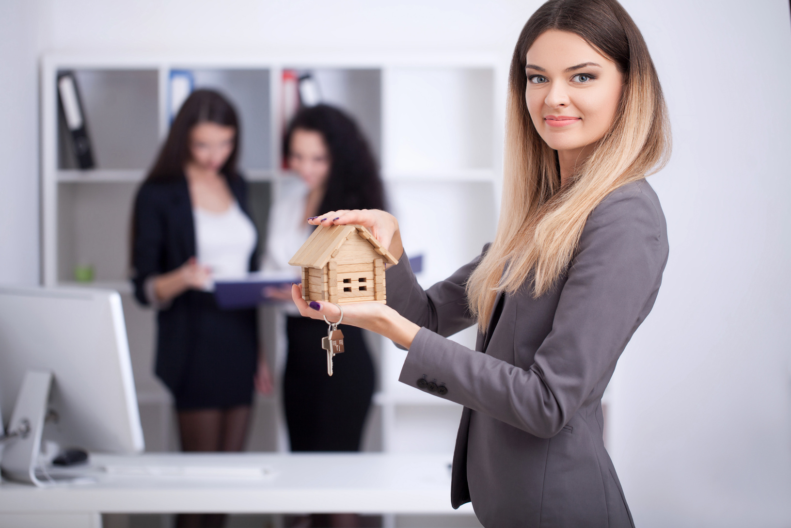Real Estate Agent Showing House Model in the Office